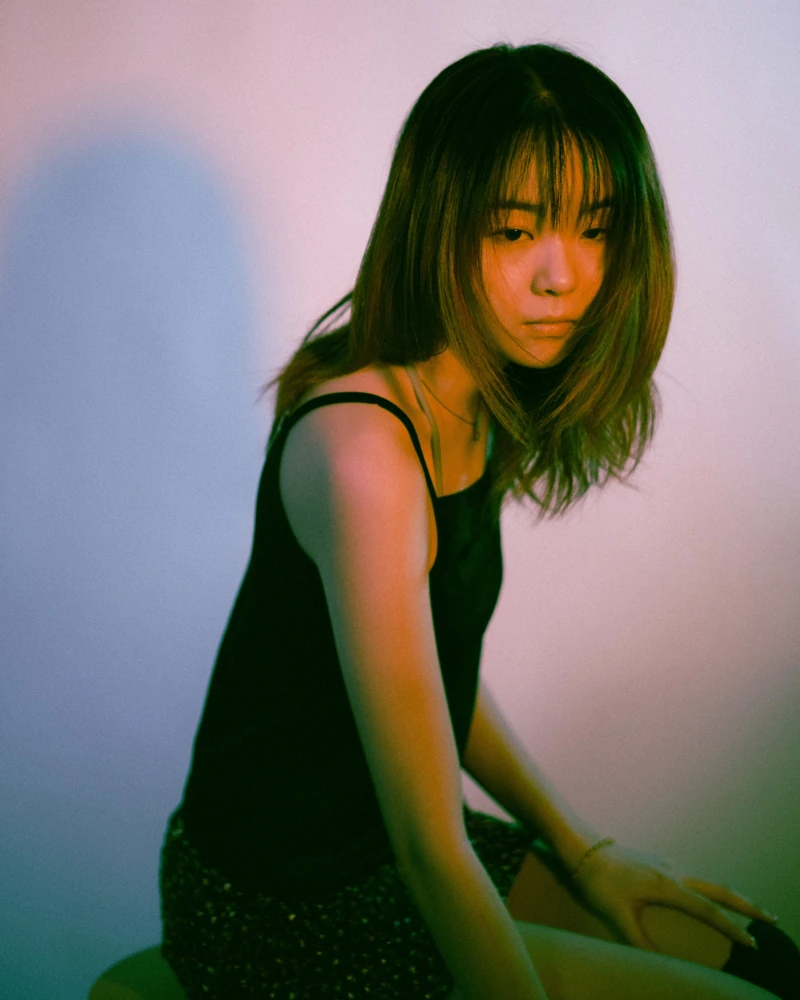 Portrait in violet, green and amber studio light