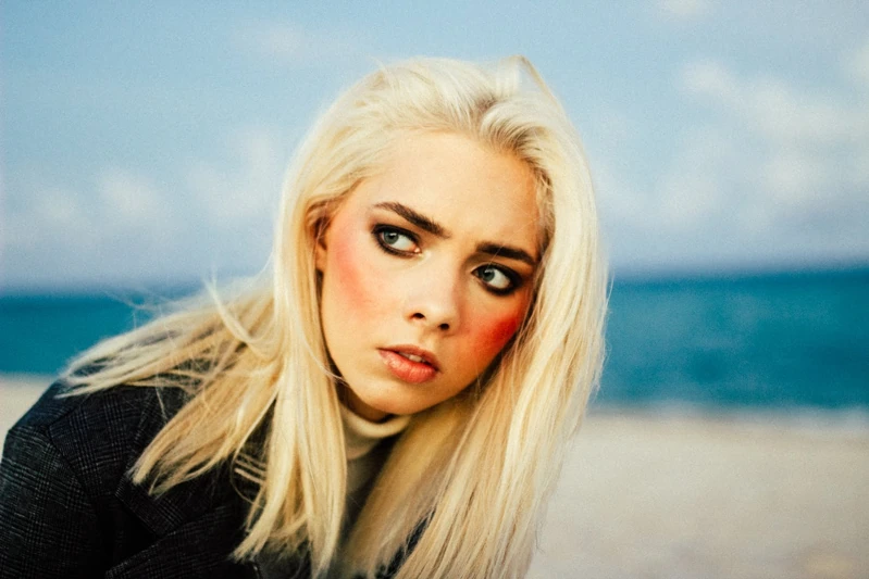 Close-up portrait with the sea in the background