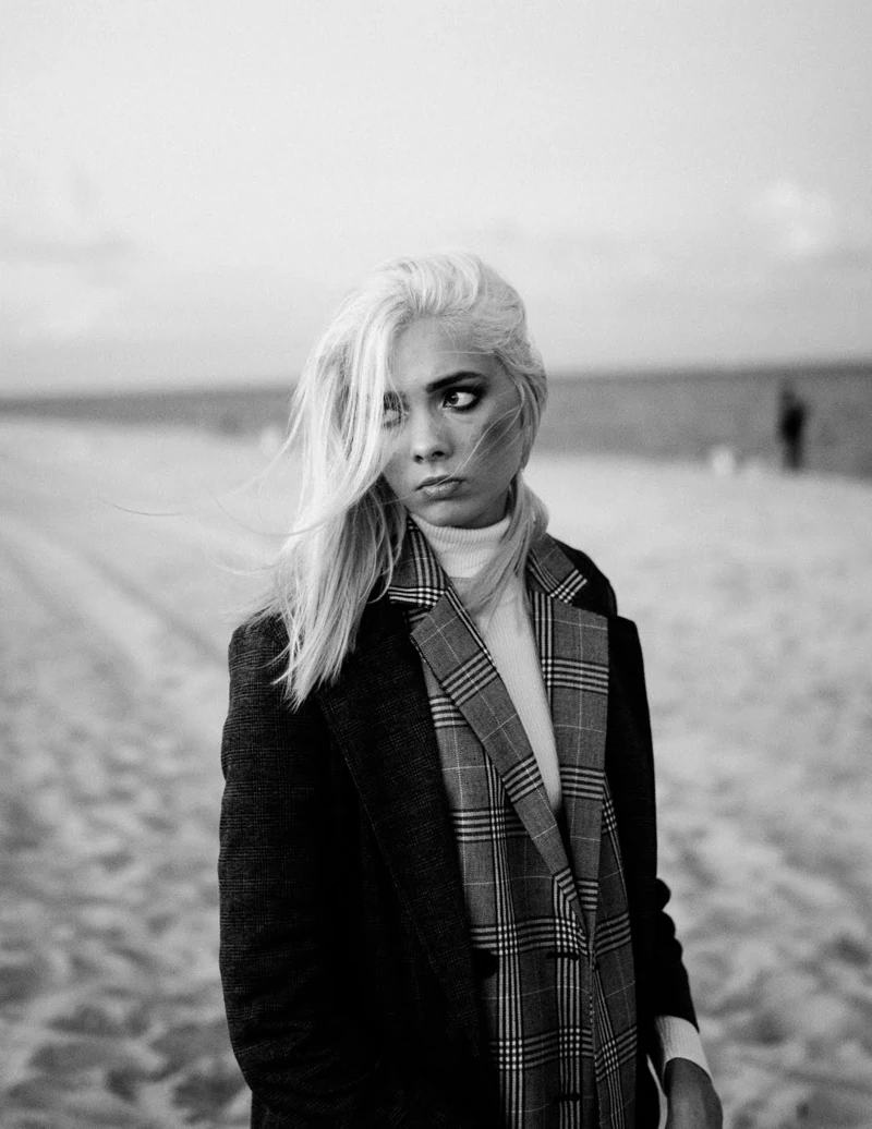 Black-and-white portrait in a checked coat