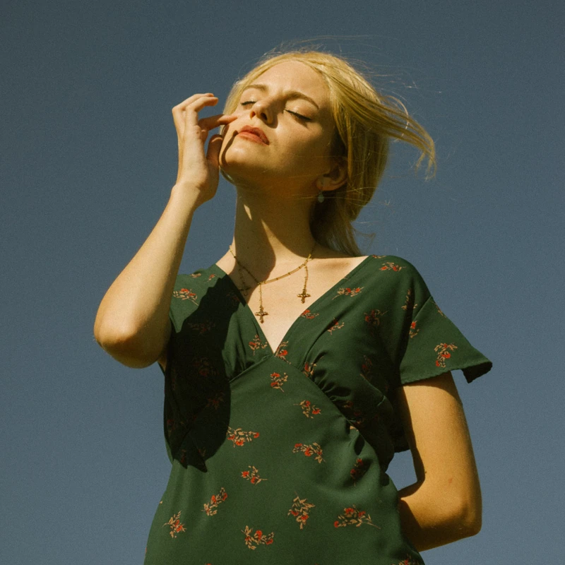 Sunlit portrait against a clear blue sky