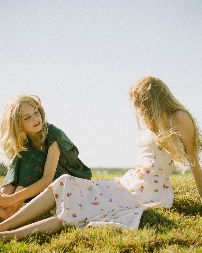 Two people sitting together in the grass
